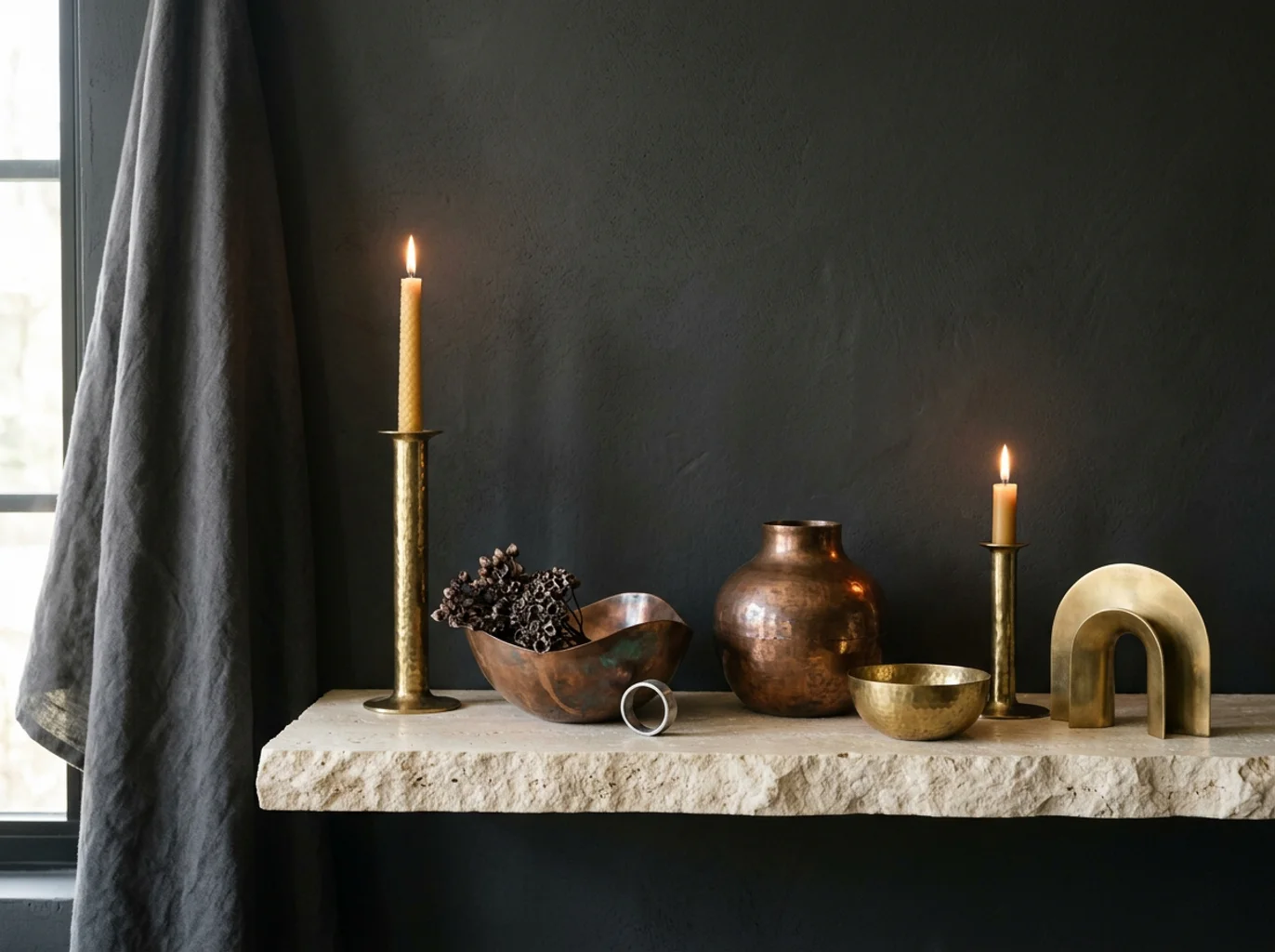 Metal craft decor vessels in brass and copper against a quiet interior